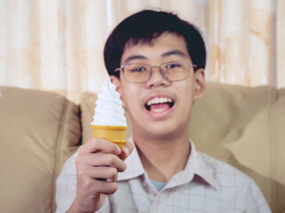 Fototapeta premium Asia boy kid hold vanilla ice cream in waffles cone happy smiling and eating deliciously in summer with have fun and good mood.