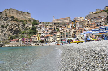 Fototapeta na wymiar Crystal clear water, at the sight of a typical village on the coast. Southern Italy