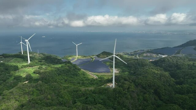 Aerial rotate around wind turbines and solar panels with patch of sun