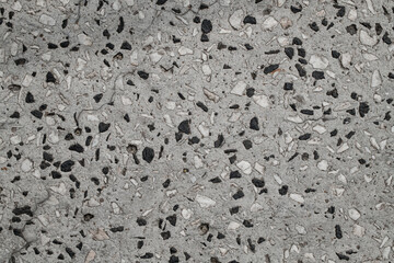 Grey granular granite texture with small stones. Granite surface and background.