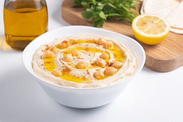 Delicious hummus with chickpeas, olive oil, lemon and pita bread. Vegetarian food concept.