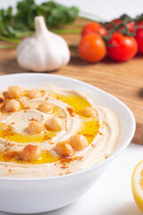 Delicious hummus with chickpeas, olive oil, lemon and pita bread. Vegetarian food concept.