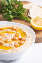 Delicious hummus with chickpeas, olive oil, lemon and pita bread. Vegetarian food concept.