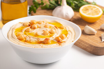 Delicious hummus with chickpeas, olive oil, lemon and pita bread. Vegetarian food concept.