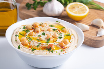 Delicious hummus with chickpeas, olive oil, lemon and pita bread. Vegetarian food concept.