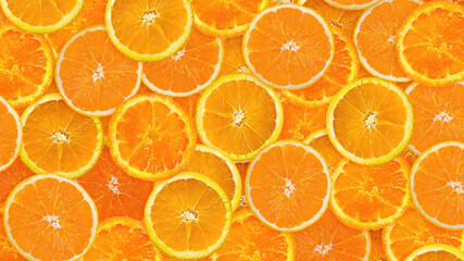 Fresh sliced mixed orange fruits background. Concept of healthy eating, dieting. Top view