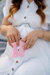 woman holding baby shoes