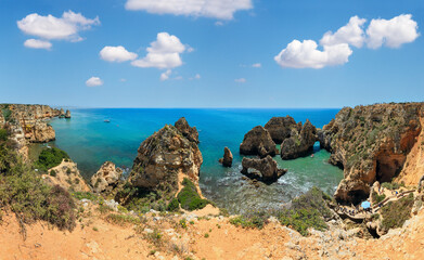 Ponta da Piedade (group of rock formations along coastline of Lagos town, Algarve, Portugal). People are unrecognizable.