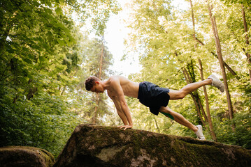 Man doing sports exercises in the forest