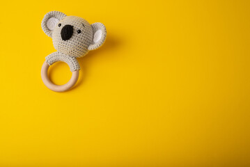 A rattle of eco materials on a yellow background