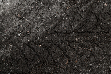 Top view on tyre track on dirt ground.