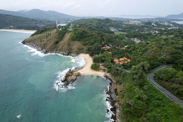 Fototapeta premium Aerial view of curve road along the seashore at Phuket Thailand beautiful seacoast and open sea in summer season Nature recovered Environment and Travel background