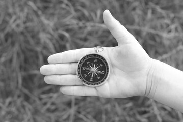 Old classic navigation compass in hand