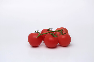 Cherry tomato bunch closeup isolated on white background.
