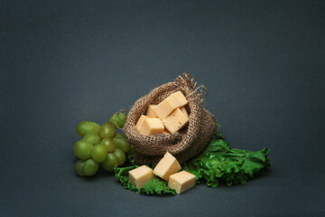 pieces of cheese in a small bag of burlap