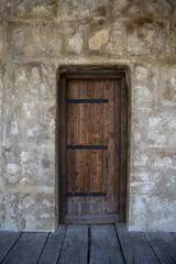 Fototapeta na wymiar Big Old Wooden Door in The Castle Inside With Stone Wall