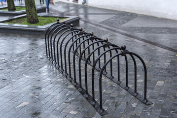 Black metal bicycle parking space or spot for multiple bikes