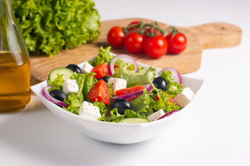 Greek salad with fresh tomatoes, cucumber, olives, feta cheese and red onion. Healthy and diet food concept.