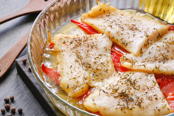 Baked cod fish served in bowl. Cooking fish in the oven. Selective focus.