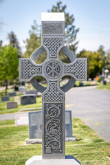 Celtic Stone Religious Cross-shaped Headstone at a Cemetery at Day
