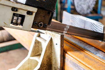 Machine for cutting metal profile. The saw cuts metal blanks into pieces. Industrial equipment for cutting and processing metal.