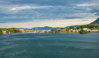 Panorama of the old town of Sitka in Alaska as the sun illuminates the downtown area - obrazy, fototapety, plakaty