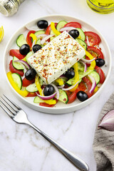 Tasty Greek Salad close-up eddited with olive oil and spices, healthy eating