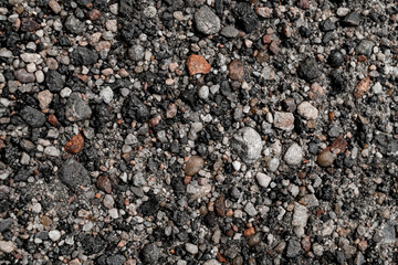 Gray and colorful small rocks as background texture. Gravel pebbles stone texture.