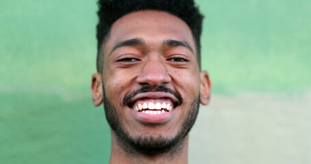 Happy young black man laughing and smiling. African ethnicity real life laugh and smile