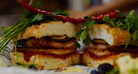 Appetizing sandwich with chicken chop and hot chili peppers. Fast food Tel Aviv