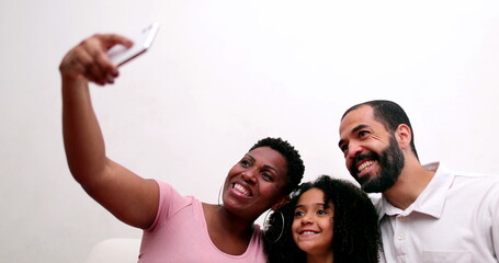 Happy multiracial family taking selfie with smartphone device. Interracial parents take photo - Powered by Adobe