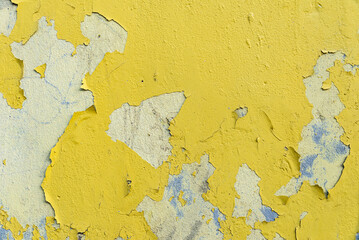 photo of a wall texture with yellow paint chipped and cracked in places
