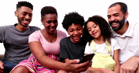 Happy mixed race family looking at phone device laughing and smiling