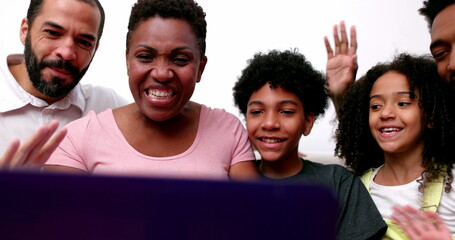 Fototapeta na wymiar Happy family video conference on laptop webcam. interracial parents and mixed race children waving