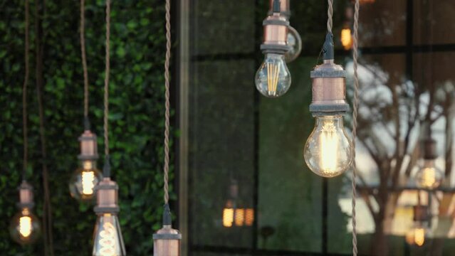 Decorative edison style antique filament light bulbs hanging on ceiling, lamp decoration outside, electric light, incandescent lamp, hot spiral of tungsten bulb