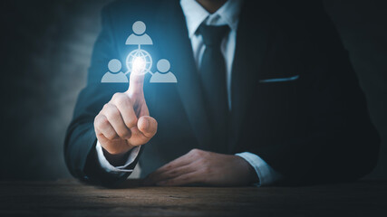 Businessman wearing formal suit pointing to company recruitment icon hologram, analysis and development solution, efficient recruitment concept, young recruitment. in startup companies.