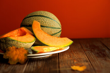 autumn still life with melon in a dark key on a wooden background
