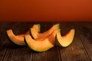 autumn still life with melon in a dark key on a wooden background