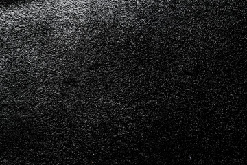 Beautiful close-up view of grungy black concrete wall as background for wallpaper