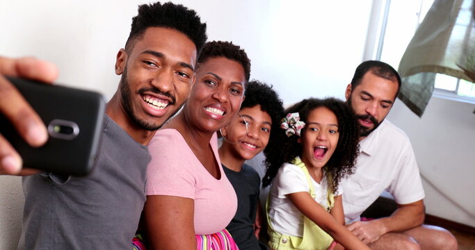 Happy black family taking selfie photo with smartphone