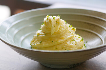 Mashed potatoes in bowl on wooden rustic table