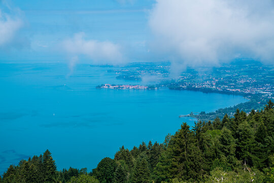 Germany, Panorama landscape view above bodensee shore and island of lindau city houses from pfaender mountain peak above tree tops