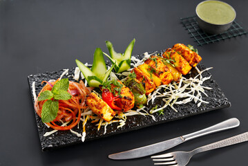 Paneer tikka is an Indian dish made from chunks of paneer marinated in spices and grilled in a tandoor