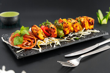 Paneer tikka is an Indian dish made from chunks of paneer marinated in spices and grilled in a...