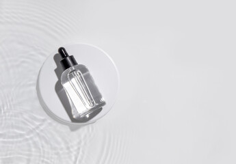 Cosmetic bottle on the water surface. Blank label for branding mock-up. Summer water pool fresh...