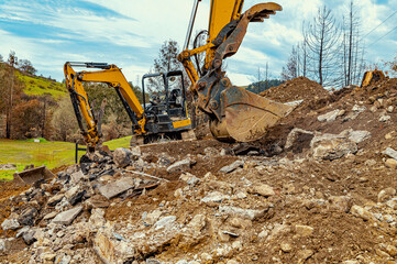 Fototapeta premium Earth, dug up by buckets of excavators. Extraction of minerals in the quarry. Mining industry.