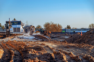 View of construction machinery and equipment in a quarry with natural materials. Loading trucks with sand.