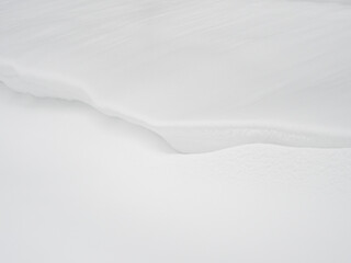 Snow drifts background, a large amount of fallen snow. White clean snow texture.