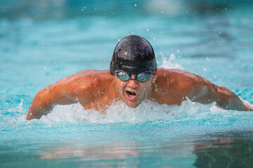 Close up of man swimming butterfly
