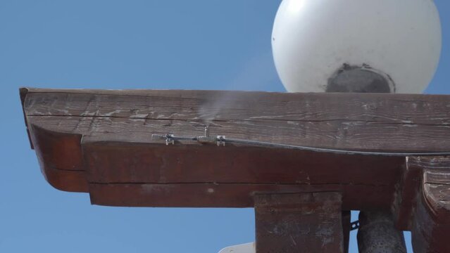 Close-up of the humidifier attached to the wooden bars in the restaurant to create the optimum temperature and humidity on the summer veranda in the resort town.